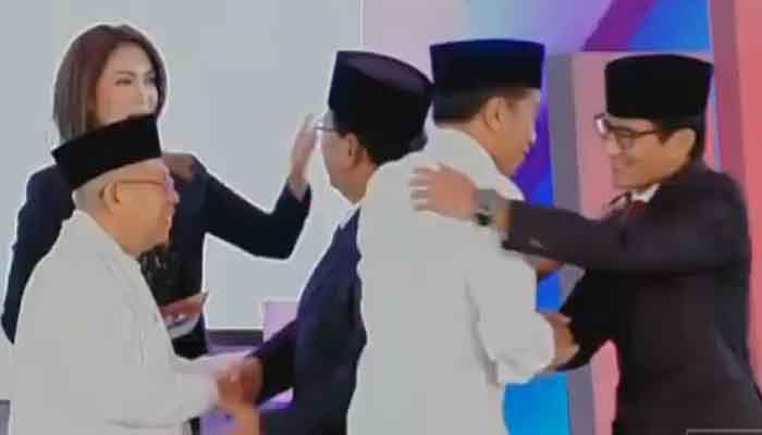 Kedua Capres-Cawapres berpelukan usai memberikan kata penutup di akhir debat perdana. (FOTO: NUSANTARANEWS.CO)